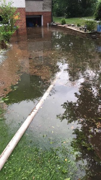 Unter Wasser stehende Garage mit Feuerwehrschlauch